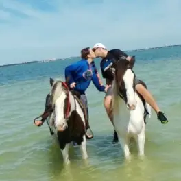 A couple sharing a kiss while on a tour