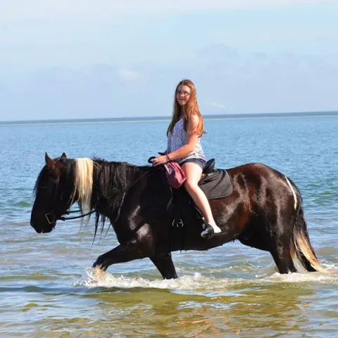 A woman riding horseback