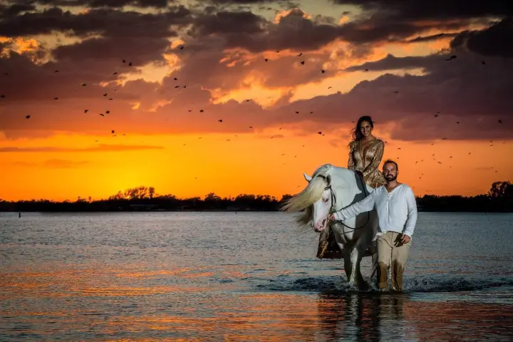 a man and a sunset over a body of water